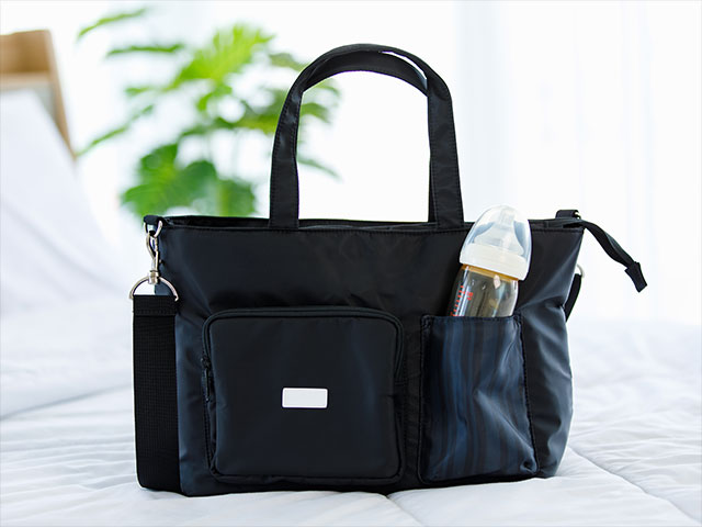 a black canvas childcare necessities carrying bag