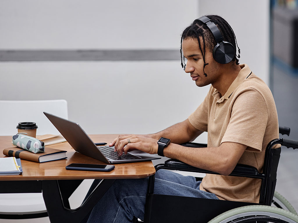 Student using wheelchair in library