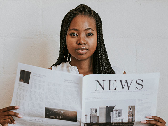 Woman holding newspaper