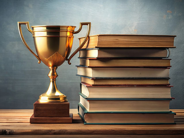 Gold trophy next to books
