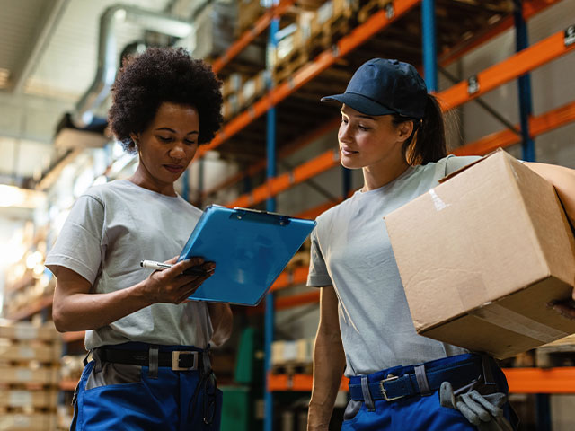 women holding packages in warehouse