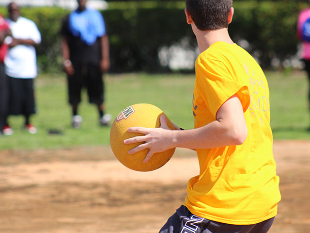 Student playing kickball