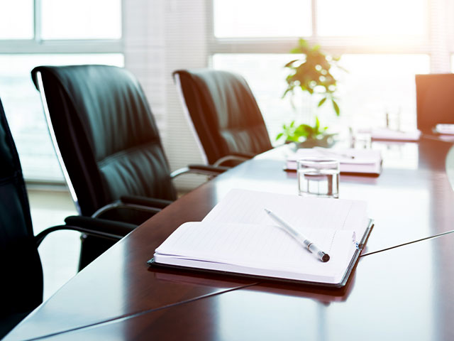 Empty Boardroom Table and Chairs