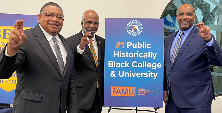 Trustee Lawson, President Robinson, and Provost Edington posing with the rattler strike. 