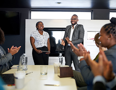 A group of individuals engaged in a meeting, discussing ideas and collaborating