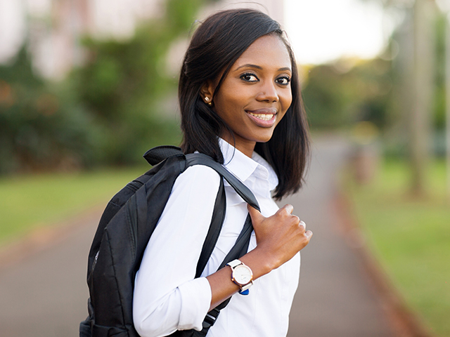 smiling African American female college student with backpack