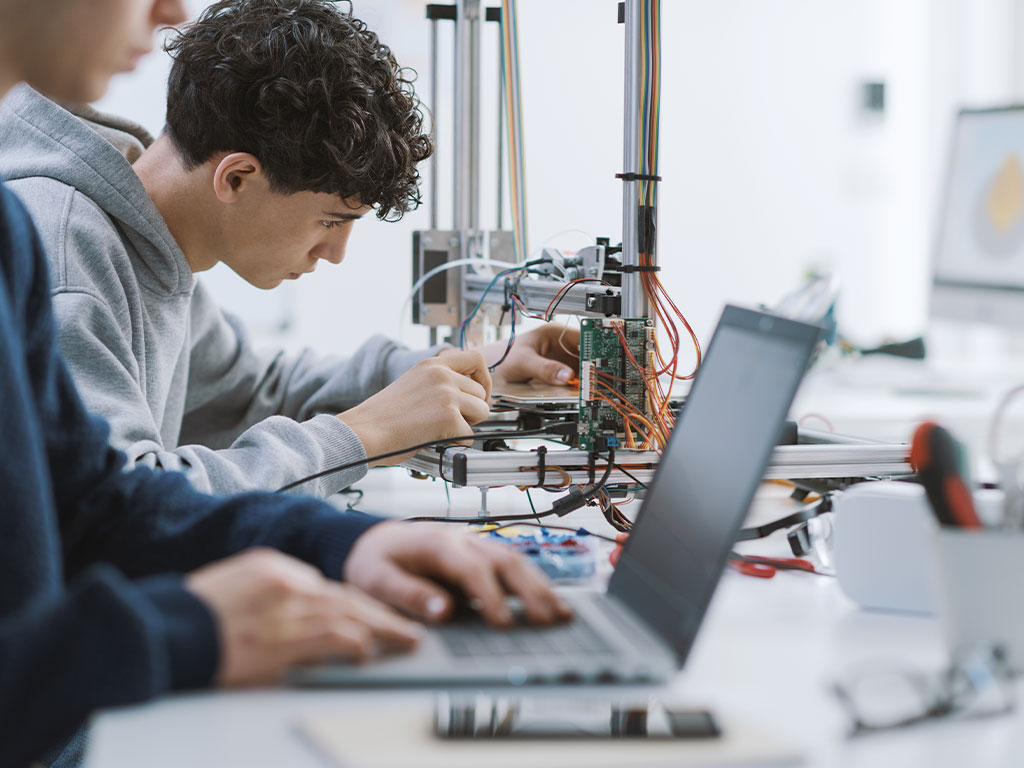 Students in classroom working on wiring