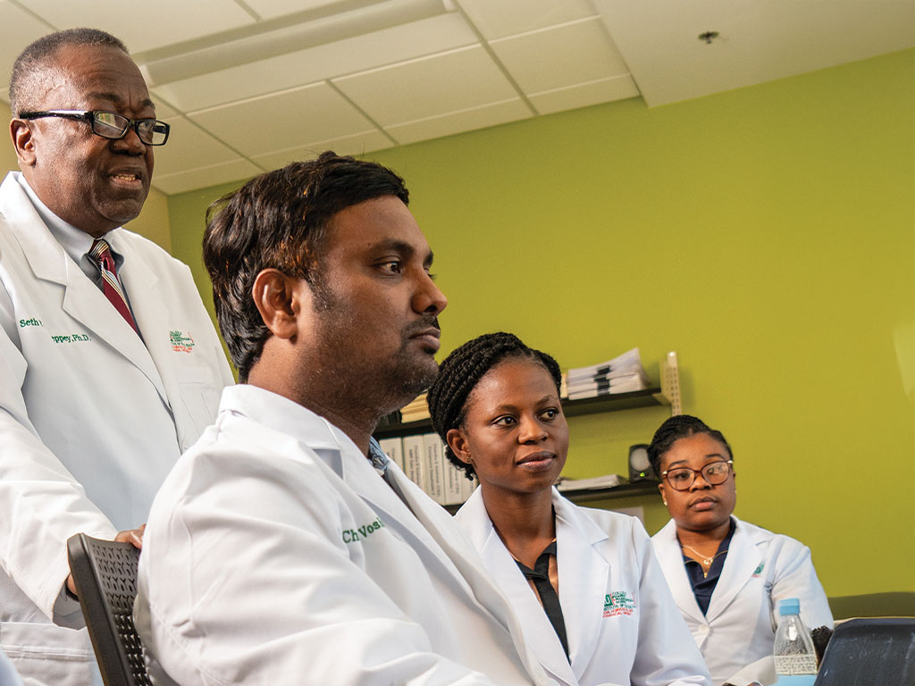 Pharmacy students reviewing lab report