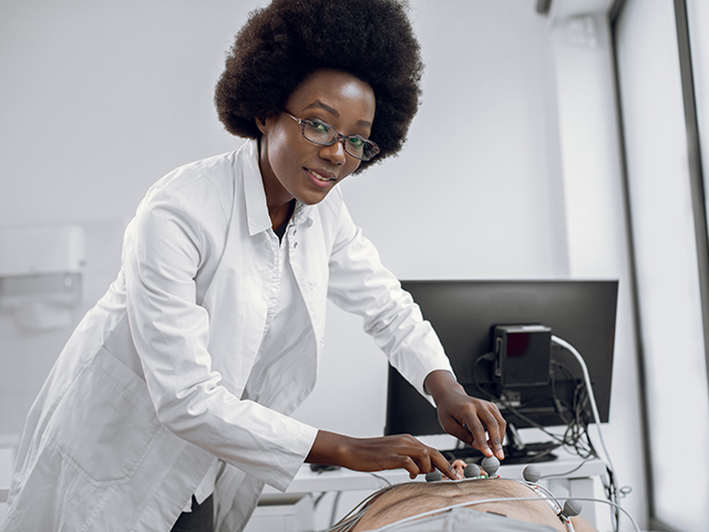 Female EKG Technician working with her patient