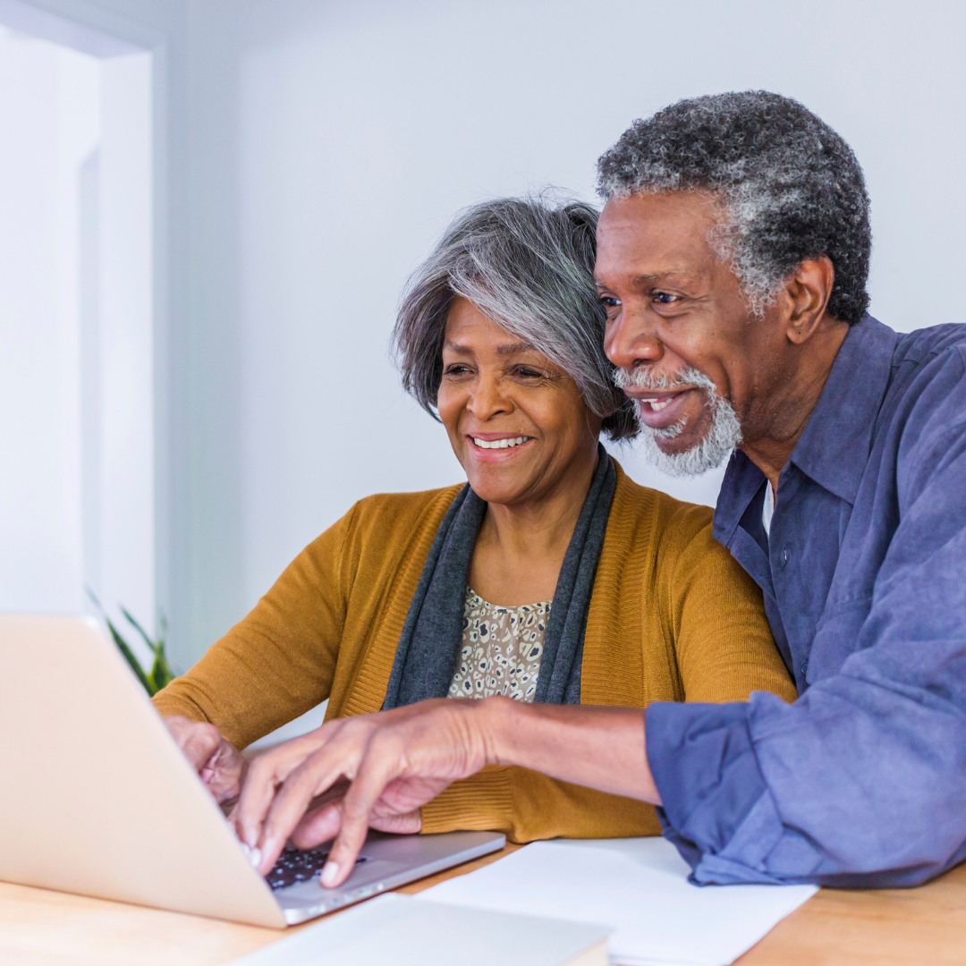 Two seniors on a computer