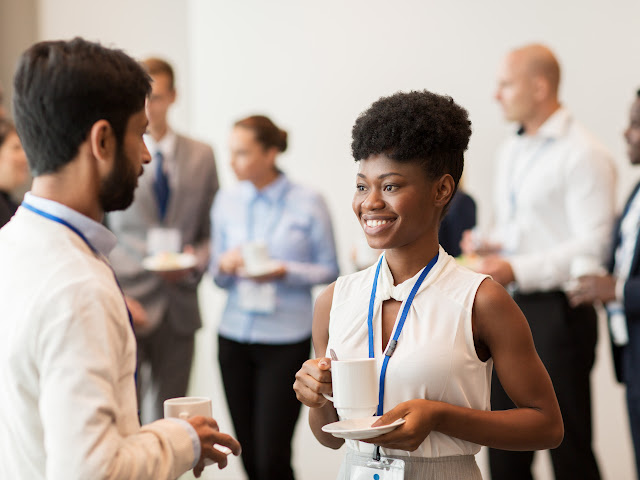 man and woman having a conversation at a conference