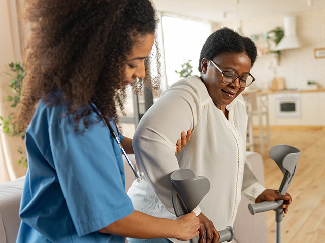 Nurse assisting elderly patient