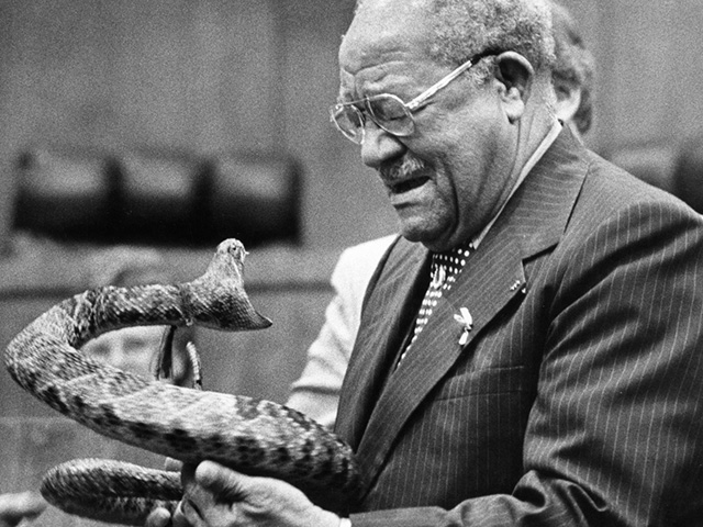 Joe Lang Kershaw, with tears in his eyes, receives a special gift from his fellow House members during a recognition ceremony on the House floor: a stuffed rattlesnake, the mascot of his Alma Mater, Florida A&M University. His colleagues are honoring him for his dedicated years of service since 1968.