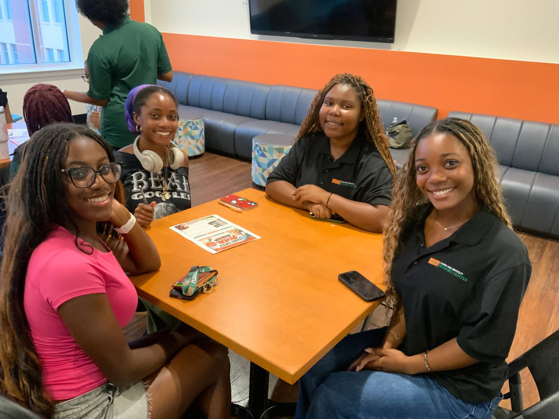 FAMU Honors students gathered around a table in a campus lounge