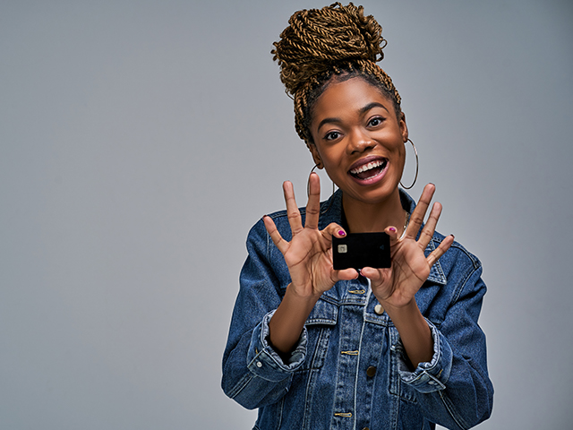 african american young woman holding a debit or credit card