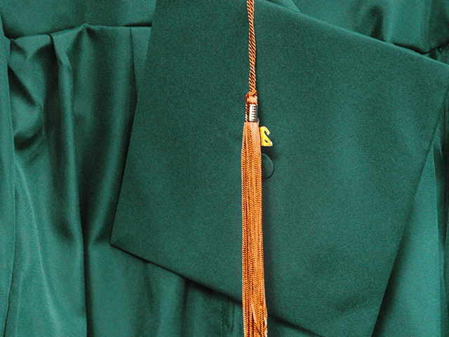 an orange and green cap and gown
