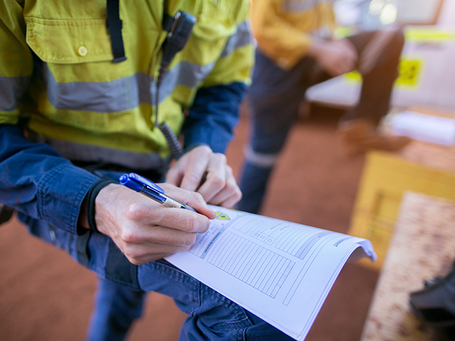 supervisor checking and reviewing a construction site