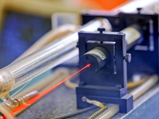 Red laser on optical table in physics laboratory