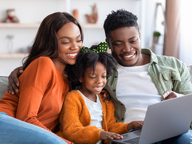 Mother, father and child looking at a tablet