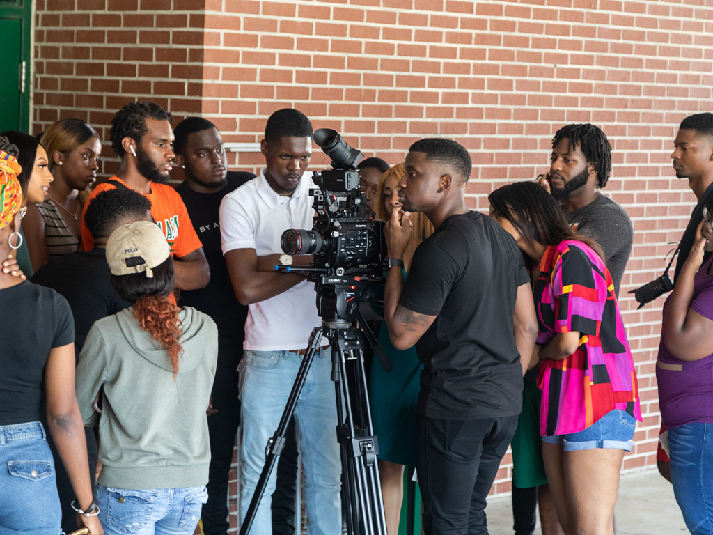 students standing around a camera