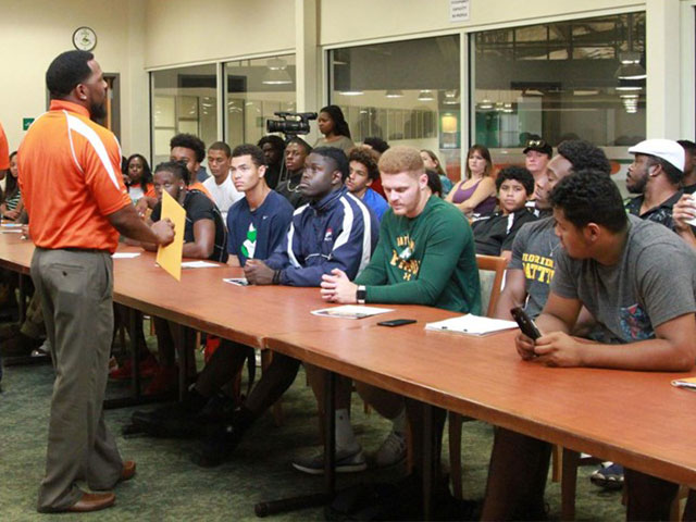 Athletes in a classroom listening to lecture