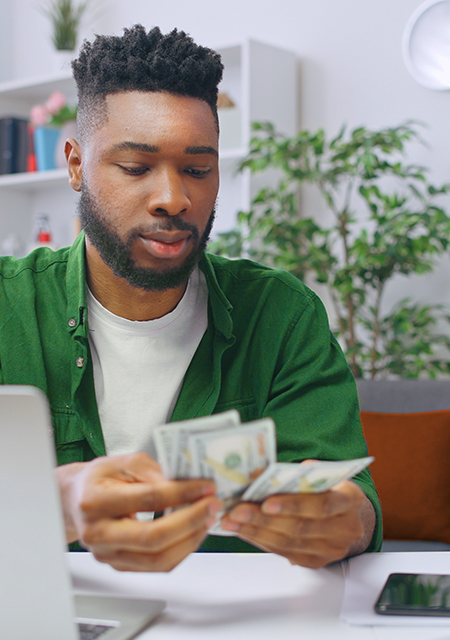 young man counting money