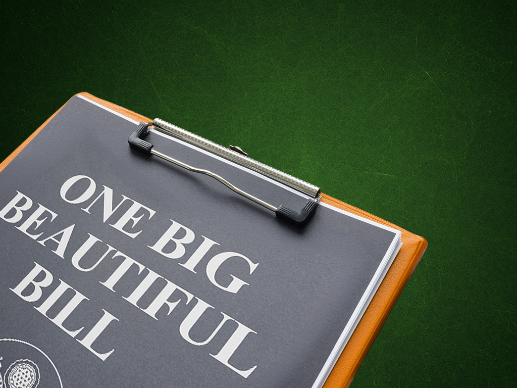 Paper on clipboard that reads "One Big Beautiful Bill" on a green background