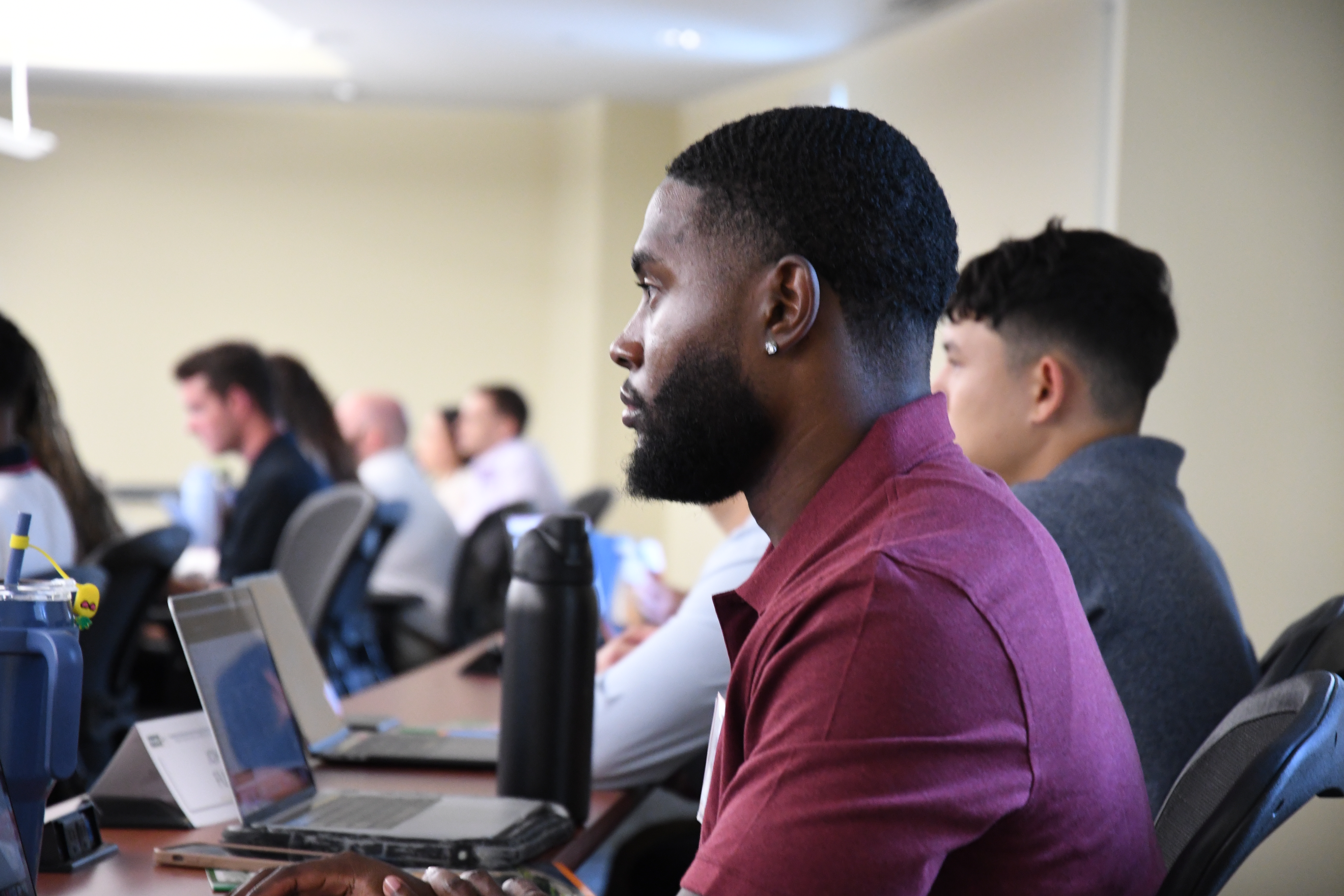African American student looking away with student in the background looking away