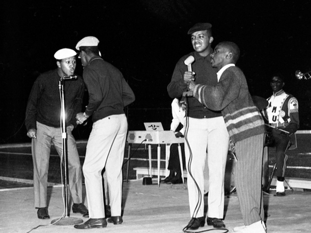 Band performing at the 1967 FAMU homecoming. Members of the "Marching 100" playing along in the background.